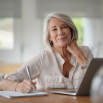 Elderly woman working on computer at home