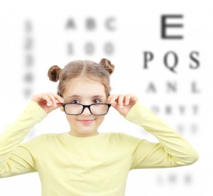 Caucasian child girl in glasses at eye sight test